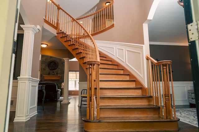 406 Elderberry Ln, Streamwood, IL 60107 - stairs featuring decorative columns, a decorative wall, wood finished floors, arched walkways, and a wainscoted wall