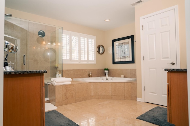 406 Elderberry Ln, Streamwood, IL 60107 - bathroom with tile patterned floors, a garden tub, a shower stall, and recessed lighting