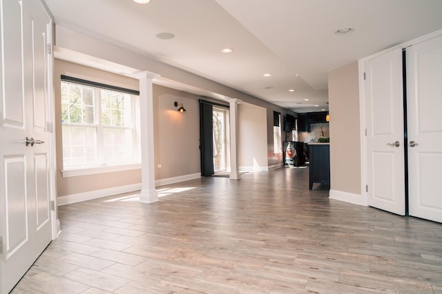 406 Elderberry Ln, Streamwood, IL 60107 - unfurnished living room featuring ornate columns, light wood finished floors, recessed lighting, and baseboards