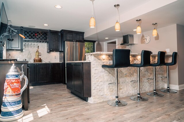 406 Elderberry Ln, Streamwood, IL 60107 - kitchen featuring light wood finished floors, tasteful backsplash, decorative light fixtures, dark cabinets, and recessed lighting