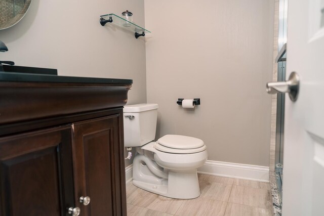 406 Elderberry Ln, Streamwood, IL 60107 - bathroom featuring toilet, vanity, and baseboards