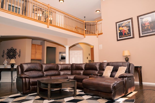 406 Elderberry Ln, Streamwood, IL 60107 - living area with decorative columns, arched walkways, dark wood-style flooring, a high ceiling, and baseboards