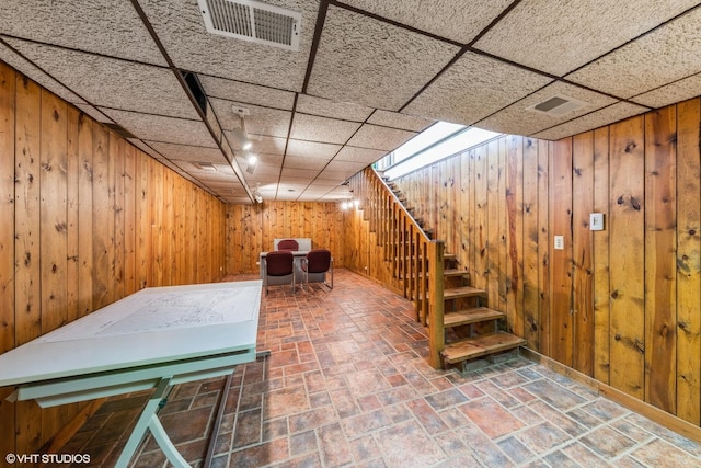 37782 N Cedar Lake Rd, Lake Villa, IL 60046 - finished basement featuring stairs, wooden walls, and a paneled ceiling