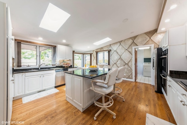 37782 N Cedar Lake Rd, Lake Villa, IL 60046 - kitchen with a skylight, appliances with stainless steel finishes, a kitchen island, white cabinetry, and recessed lighting