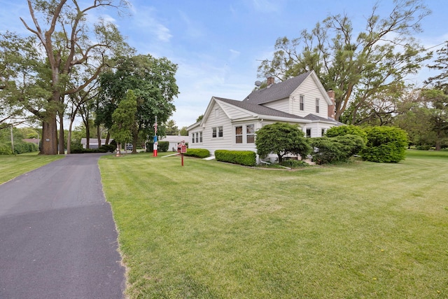30W311 W Bartlett Rd, Bartlett, IL 60103 - view of side of property featuring a lawn, a chimney, and a shingled roof