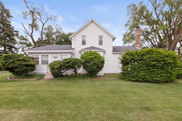 30W311 W Bartlett Rd, Bartlett, IL 60103 - view of home's exterior featuring a lawn, a chimney, a shingled roof, and entry steps