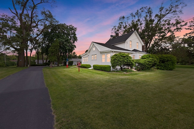 30W311 W Bartlett Rd, Bartlett, IL 60103 - property exterior at dusk featuring a lawn