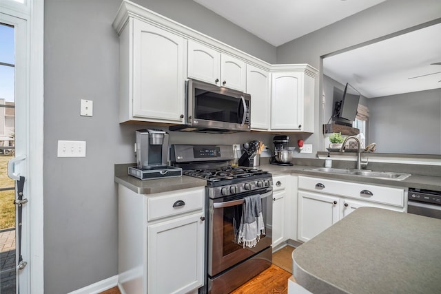 1014 Bayside Ln, Shorewood, IL 60404 - kitchen with stainless steel appliances, a sink, and white cabinetry