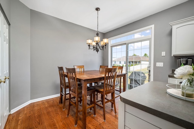 1014 Bayside Ln, Shorewood, IL 60404 - dining space featuring wood finished floors, a chandelier, and baseboards