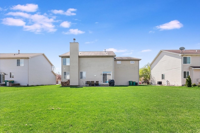 1014 Bayside Ln, Shorewood, IL 60404 - rear view of property with a chimney and a lawn