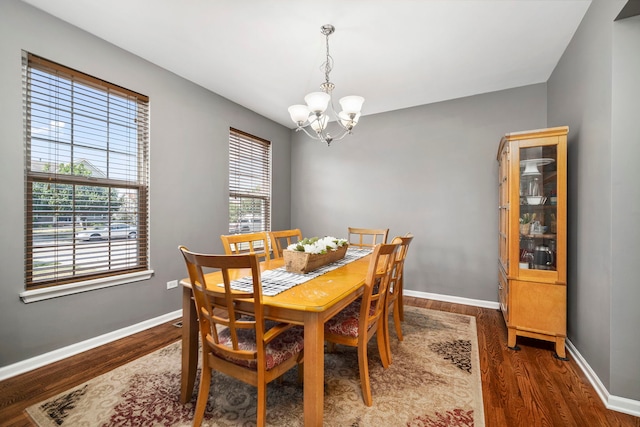 1014 Bayside Ln, Shorewood, IL 60404 - dining area with a chandelier, wood finished floors, and baseboards
