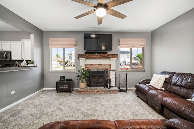 1014 Bayside Ln, Shorewood, IL 60404 - carpeted living room with ceiling fan, baseboards, and a brick fireplace