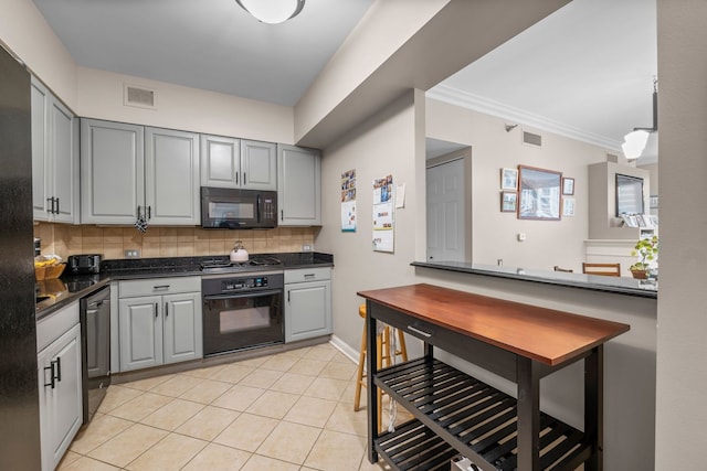 25 E Superior St Unit 903, Chicago, IL 60611 - kitchen with black appliances, gray cabinets, dark countertops, backsplash, and ornamental molding