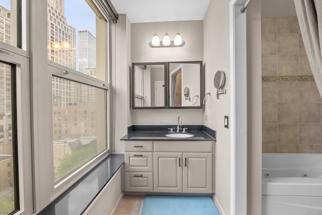 25 E Superior St Unit 903, Chicago, IL 60611 - full bathroom with vanity, a combined bath / shower with jetted tub, plenty of natural light, and baseboards
