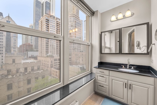 25 E Superior St Unit 903, Chicago, IL 60611 - bathroom with a view of city, vanity, and tile patterned flooring