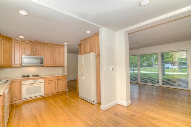 6N002 Laurel Dr, Medinah, IL 60157 - kitchen with white appliances, light wood-style floors, light countertops, recessed lighting, and baseboards