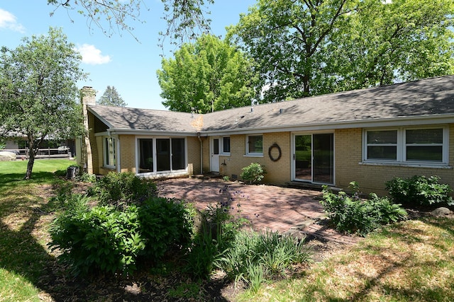 6N002 Laurel Dr, Medinah, IL 60157 - back of house featuring brick siding, a chimney, a patio, and a shingled roof