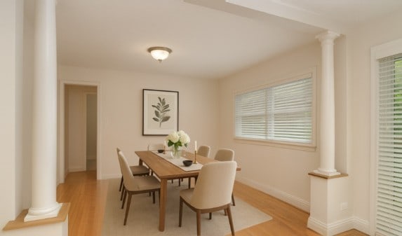 6N002 Laurel Dr, Medinah, IL 60157 - dining space with ornate columns, light wood-type flooring, and baseboards