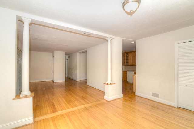 6N002 Laurel Dr, Medinah, IL 60157 - empty room featuring light wood-style floors, decorative columns, and baseboards