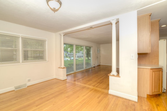 6N002 Laurel Dr, Medinah, IL 60157 - unfurnished room with ornate columns, light wood-style floors, and baseboards