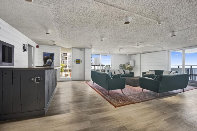 6033 N Sheridan Rd Unit 8E, Chicago, IL 60660 - living area featuring a textured ceiling, light wood finished floors, and healthy amount of natural light