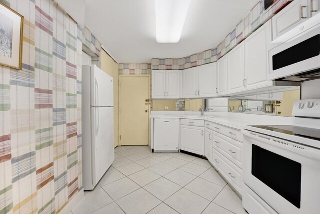 6033 N Sheridan Rd Unit 8E, Chicago, IL 60660 - kitchen with white appliances, light countertops, white cabinets, a sink, and light tile patterned flooring