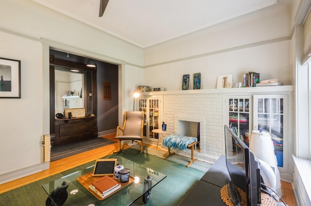 1458 W Argyle St Unit 1N, Chicago, IL 60640 - sitting room with wood finished floors, a brick fireplace, crown molding, and baseboards