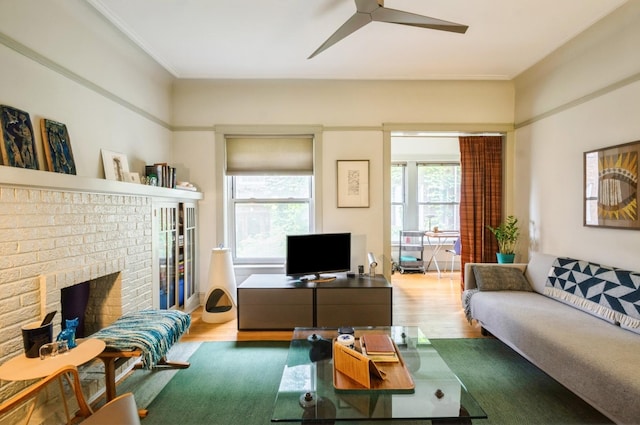 1458 W Argyle St Unit 1N, Chicago, IL 60640 - living area with healthy amount of natural light, wood finished floors, a ceiling fan, and a brick fireplace