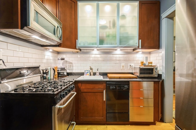 1458 W Argyle St Unit 1N, Chicago, IL 60640 - kitchen featuring dishwasher, stainless steel range with gas cooktop, a sink, and tasteful backsplash