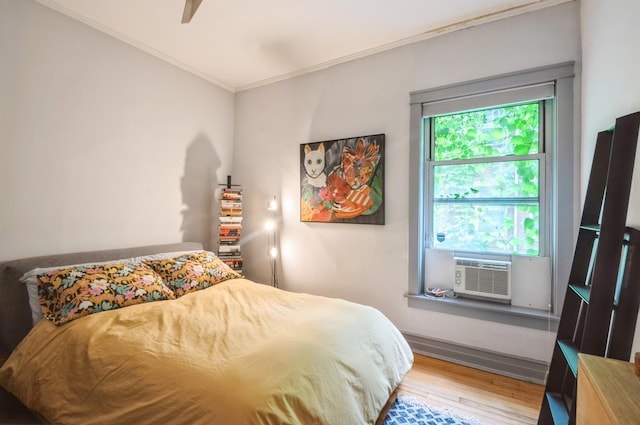 1458 W Argyle St Unit 1N, Chicago, IL 60640 - bedroom featuring wood finished floors, ornamental molding, cooling unit, and ceiling fan