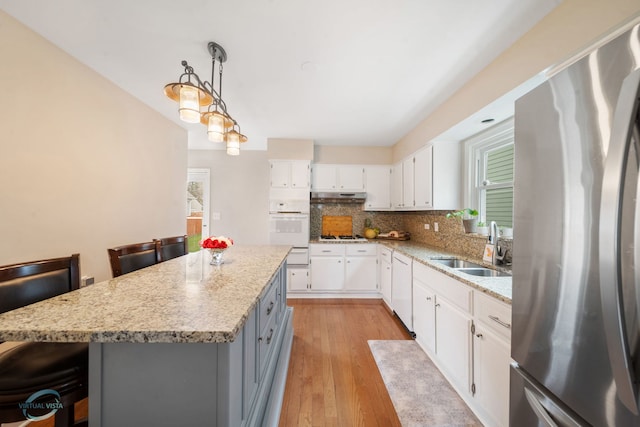 5317 Benton Ave, Downers Grove, IL 60515 - kitchen featuring white appliances, a sink, under cabinet range hood, decorative backsplash, and white cabinetry