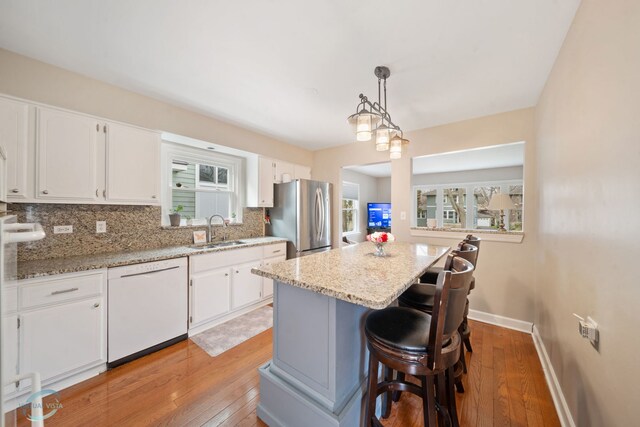 5317 Benton Ave, Downers Grove, IL 60515 - kitchen with dishwasher, freestanding refrigerator, a sink, and light wood finished floors