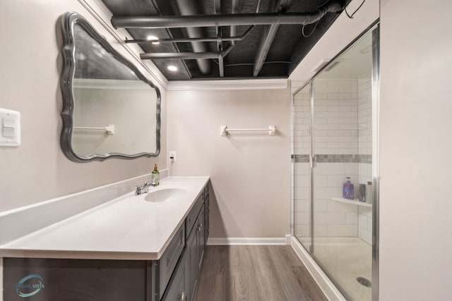 5317 Benton Ave, Downers Grove, IL 60515 - bathroom featuring vanity, wood finished floors, a stall shower, ornamental molding, and baseboards