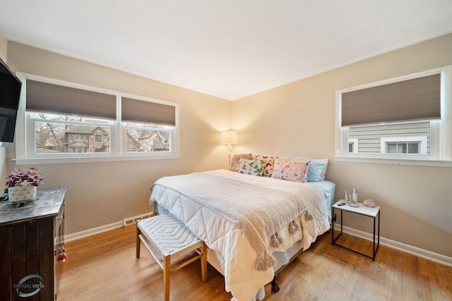 5317 Benton Ave, Downers Grove, IL 60515 - bedroom featuring multiple windows, baseboards, and wood finished floors