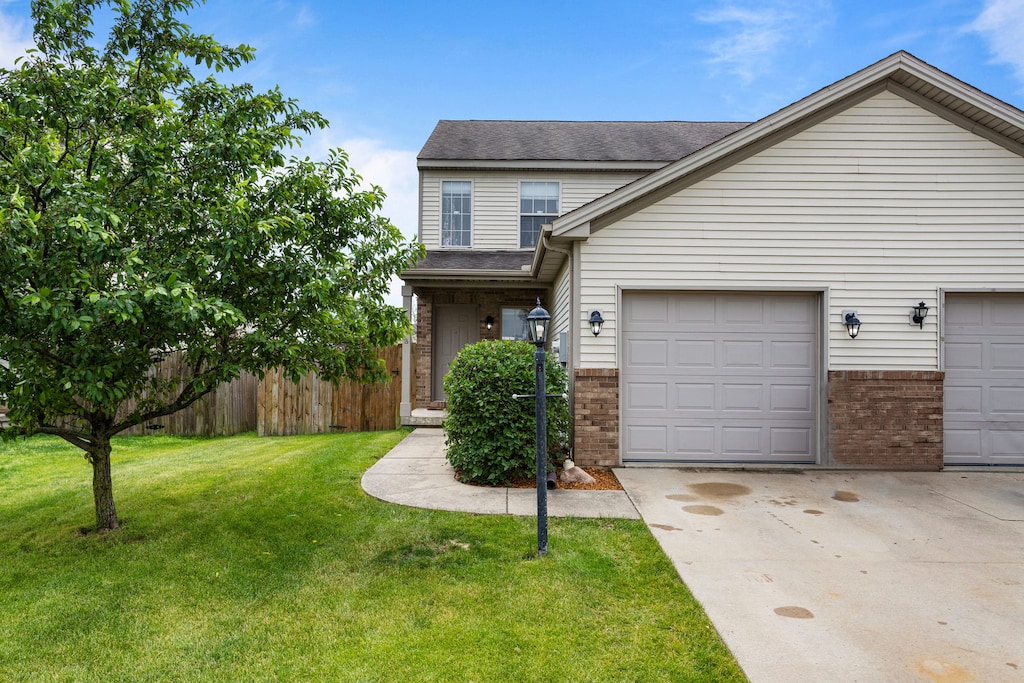 3709 Boulder Ridge Dr, Champaign, IL 61822 - traditional-style house with brick siding, an attached garage, concrete driveway, and a shingled roof