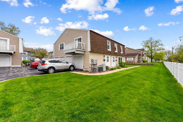 1585 Woodcutter Ln Unit D, Wheaton, IL 60189 - view of property exterior with a gambrel roof, a shingled roof, asphalt driveway, an attached garage, and central air condition unit