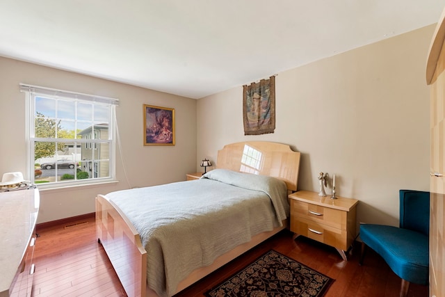 1585 Woodcutter Ln Unit D, Wheaton, IL 60189 - bedroom featuring dark wood finished floors and baseboards
