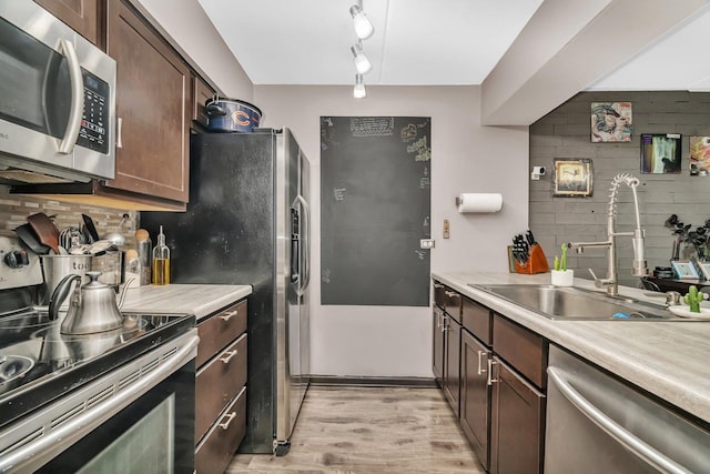 14028 Laramie Ave Unit 1719, Crestwood, IL 60418 - kitchen featuring appliances with stainless steel finishes, a sink, light wood-style flooring, and light countertops