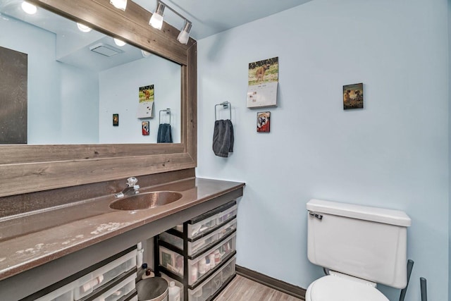 14028 Laramie Ave Unit 1719, Crestwood, IL 60418 - bathroom with toilet, vanity, baseboards, and wood finished floors