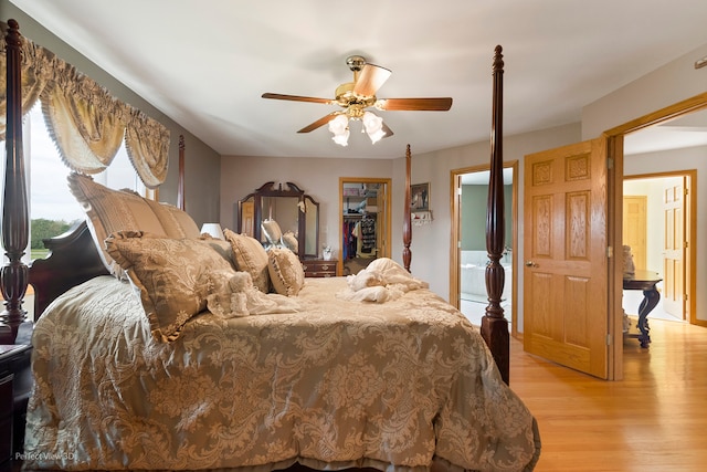 13836 W Joliet Rd, Manhattan, IL 60442 - bedroom featuring light wood-style flooring, a spacious closet, a closet, and a ceiling fan