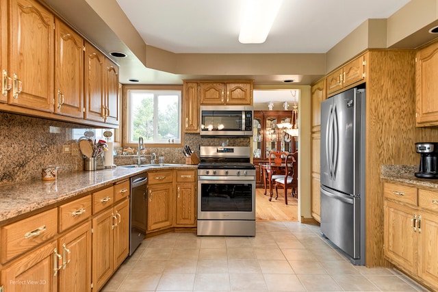 13836 W Joliet Rd, Manhattan, IL 60442 - kitchen with appliances with stainless steel finishes, a sink, decorative backsplash, and light stone counters