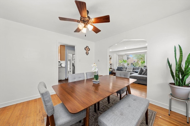 9141 S Albany Ave S, Evergreen Park, IL 60805 - dining room with arched walkways, baseboards, light wood-style flooring, and ceiling fan
