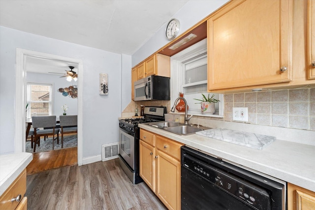 9141 S Albany Ave S, Evergreen Park, IL 60805 - kitchen featuring appliances with stainless steel finishes, a sink, light countertops, and wood finished floors