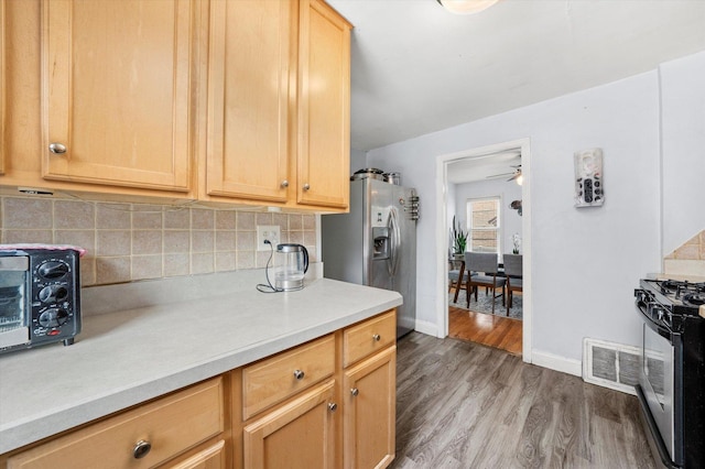 9141 S Albany Ave S, Evergreen Park, IL 60805 - kitchen featuring stainless steel appliances, tasteful backsplash, light countertops, light wood-type flooring, and baseboards