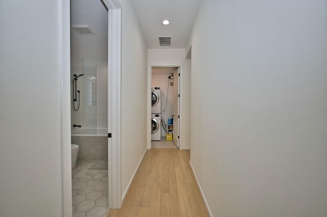 522 N Western Ave Unit 201, Chicago, IL 60612 - corridor featuring stacked washer and clothes dryer, light wood-type flooring, baseboards, and recessed lighting