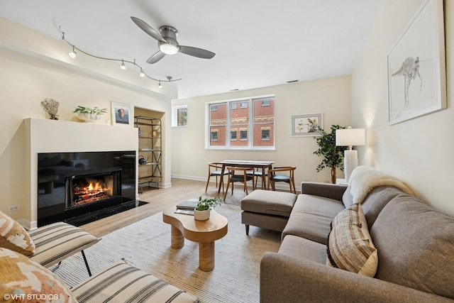 3721 N Sheffield Ave Unit B2, Chicago, IL 60613 - living area featuring a ceiling fan, light wood-type flooring, a fireplace with flush hearth, baseboards, and track lighting