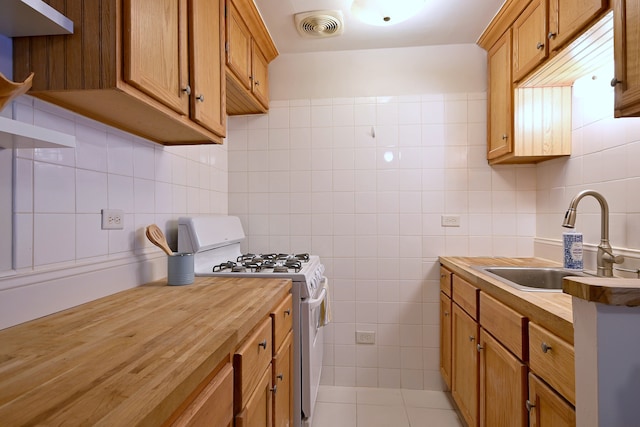 5816 N Nagle Ave Unit B, Chicago, IL 60646 - kitchen with wooden counters, white range with gas cooktop, a sink, tasteful backsplash, and tile walls