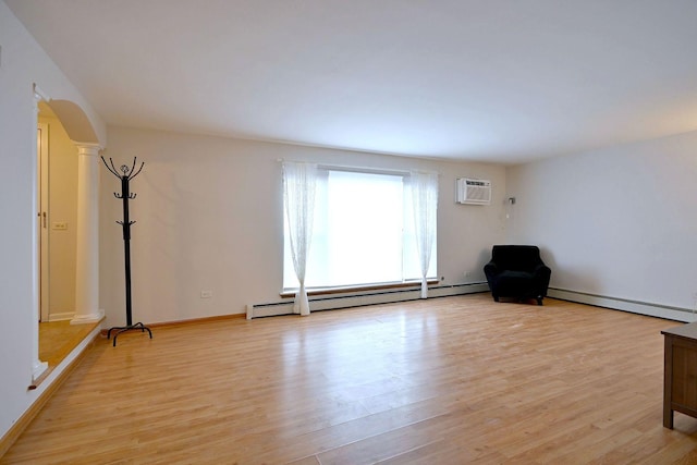 5816 N Nagle Ave Unit B, Chicago, IL 60646 - unfurnished room with arched walkways, a baseboard radiator, light wood-style floors, and a wall mounted air conditioner