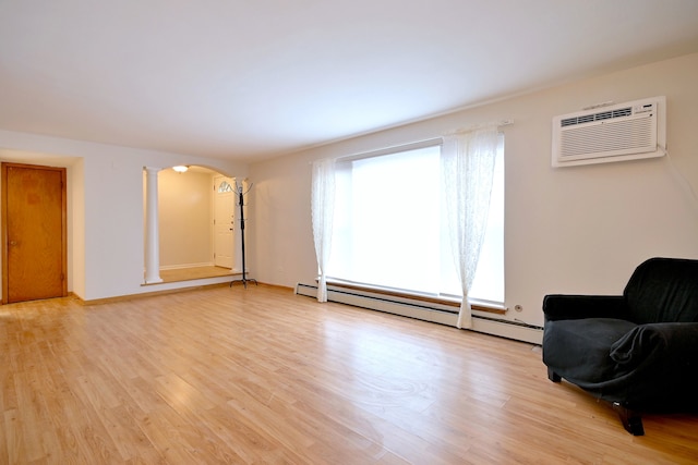 5816 N Nagle Ave Unit B, Chicago, IL 60646 - sitting room featuring a wall mounted AC, a baseboard heating unit, arched walkways, and light wood finished floors
