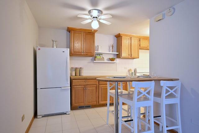 5816 N Nagle Ave Unit B, Chicago, IL 60646 - kitchen featuring freestanding refrigerator, ceiling fan, open shelves, decorative backsplash, and light tile patterned flooring